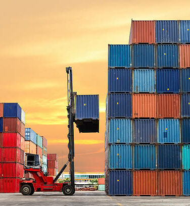 Crane lifting up container in yard